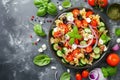 Pasta salad with tomatoes, cucumbers, olives, mozzarella and red onion Greek style Royalty Free Stock Photo