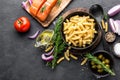 Pasta, salmon fish and ingredients for cooking on black background, top view. Italian food