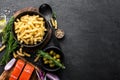 Pasta, salmon fish and ingredients for cooking on black background, top view. Italian food Royalty Free Stock Photo