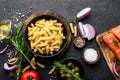 Pasta, salmon fish and ingredients for cooking on black background, top view Royalty Free Stock Photo