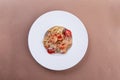 Pasta with salmon, shrimp, red caviar and tomatoes in a plate. close-up. Royalty Free Stock Photo