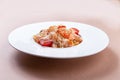 Pasta with salmon, shrimp, red caviar and tomatoes in a plate. close-up. Royalty Free Stock Photo