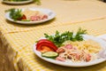 Pasta with sausage and tomatoes with greens on a white plate Royalty Free Stock Photo