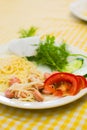 Pasta with sausage and tomatoes with greens on a white plate Royalty Free Stock Photo