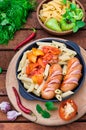 Pasta with sausages and lecho. Wooden rustic background. Selective focus. Top view Royalty Free Stock Photo