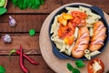 Pasta with sausages and lecho. Wooden rustic background. Selective focus. Top view Royalty Free Stock Photo