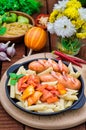 Pasta with sausages and lecho. Wooden rustic background. Selective focus. Top view Royalty Free Stock Photo