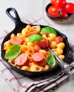 Pasta with sausages in tomato sauce with basil and cheese Royalty Free Stock Photo