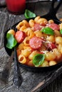 Pasta with sausages in tomato sauce with basil and cheese Royalty Free Stock Photo