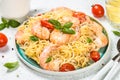 Pasta seafood with shrimp on white table.