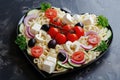 Pasta in the shape heart salad with tomatoes, cucumbers, olives, mozzarella and red onion Greek style Royalty Free Stock Photo