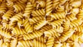 Pasta in the shape of a spiral. Macro photo of pasta. Pasta background. Pasta in bulk Royalty Free Stock Photo
