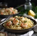 Pasta with shrimp, cheese sauce and herbs in a pan, kitchen in the background Royalty Free Stock Photo