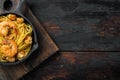 Pasta with shrimp, and pesto sauce , in cast iron frying pan, on old dark  wooden table , top view flat lay, with copy space for Royalty Free Stock Photo