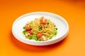 Pasta with shrimp and tomato in a plate on an orange background. Royalty Free Stock Photo