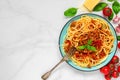 Pasta spaghetti bolognese on a blue plate with fork on white marble table. healthy food. top view Royalty Free Stock Photo