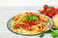 Pasta spaghetti bolognese on a blue plate with fork on white wooden table. healthy food Royalty Free Stock Photo