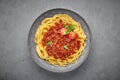 Pasta Spaghetti Bolognese in gray bowl on concrete background. Bolognese sauce is classic italian cuisine dish