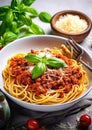 Pasta spaghetti bolognese with minced beef sauce, tomatoes, parmesan cheese and fresh basil in a plate on white table Royalty Free Stock Photo