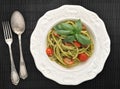 Pasta spaghetti with cherry tomatoes and basilikum in a plate Royalty Free Stock Photo