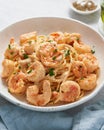 Pasta spaghetti with grilled shrimps sauce. Spaghetti with seafood. Macro side view, vertical Royalty Free Stock Photo