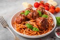 Pasta spaghetti with meatballs, tomato sauce, parmesan cheese and basil in a plate with fork. italian food Royalty Free Stock Photo