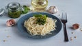 Pasta spaghetti with pesto and ingredients on white wooden background. Royalty Free Stock Photo