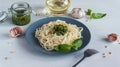 Pasta spaghetti with pesto and ingredients on white wooden background. Royalty Free Stock Photo