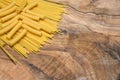 Pasta, spaghetti and sedani on an olive wood cutting board Royalty Free Stock Photo