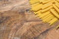 Pasta, spaghetti and sedani on an olive wood cutting board Royalty Free Stock Photo