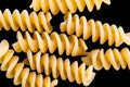 Pasta, spaghetti, shells, rings, bows on a black or white background top view