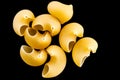 Pasta, spaghetti, shells, rings, bows on a black or white background top view