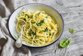 Pasta with spinach and cream sauce on vintage enameled plate