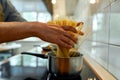 Pasta time. Close up of hands of man, professional cook cooking pasta spaghetti at home in the kitchen. Home cooking Royalty Free Stock Photo