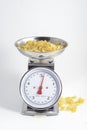 Pasta to be cooked on weighing scales Royalty Free Stock Photo