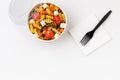 Pasta with tomato and feta in taking away box on white table