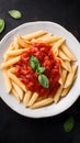 Pasta with tomato sauce and basil garnish, simple background, space reserved for recipe Royalty Free Stock Photo