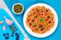 Pasta with tomato sauce, capers and olives