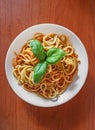 Pasta with tomato sauce, green basil, white plate Royalty Free Stock Photo