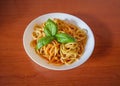 Pasta with tomato sauce, green basil, white plate Royalty Free Stock Photo