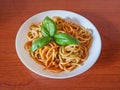 Pasta with tomato sauce, green basil, white plate Royalty Free Stock Photo