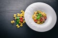 Pasta with tomatoes and basil. Plate with the word