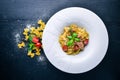 Pasta with tomatoes and basil. Plate with the word