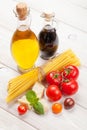 Pasta, tomatoes, basil on wooden table Royalty Free Stock Photo