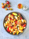 Pasta with tomatoes in a bowl. Vegan bowl with pasta and different varieties of tomato. Royalty Free Stock Photo