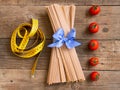 Pasta and tomatoes on wooden background Royalty Free Stock Photo