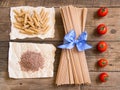 Pasta and tomatoes on wooden background Royalty Free Stock Photo