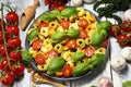 Pasta. tricolor tortellini pasta salad with tomatoes and onions on wood table background Royalty Free Stock Photo