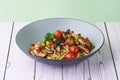 Pasta truffle Aglio Oglio with mushroom and tomatoes in a bowl on wooden background