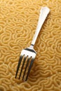 Pasta tubes background with fork Royalty Free Stock Photo